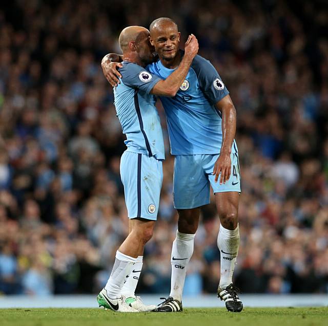 CITY stars Vincent Kompany (right) and Pablo Zabaleta embrace