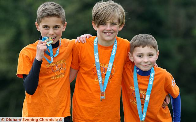 WE DID IT . . . (left to right) are successful Dobcross trio Edward Rankin (winner of the Years Five and Six race), Harry Thornley (second in the Years Five and Six boys' race) and George Cocking (third in the Boys' Years Three and Four race).
