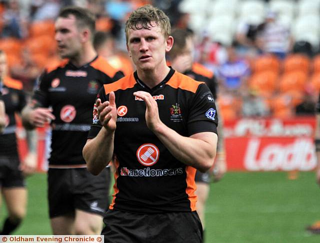 A DEJECTED Gareth Owen applauds the Oldham fans after defeat by Rochdale. 