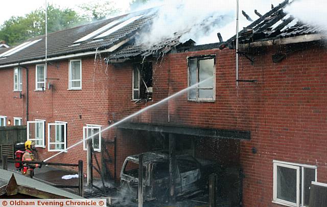 FIREFIGHTERS tackling the fire that hit three houses in Woodstock Street.