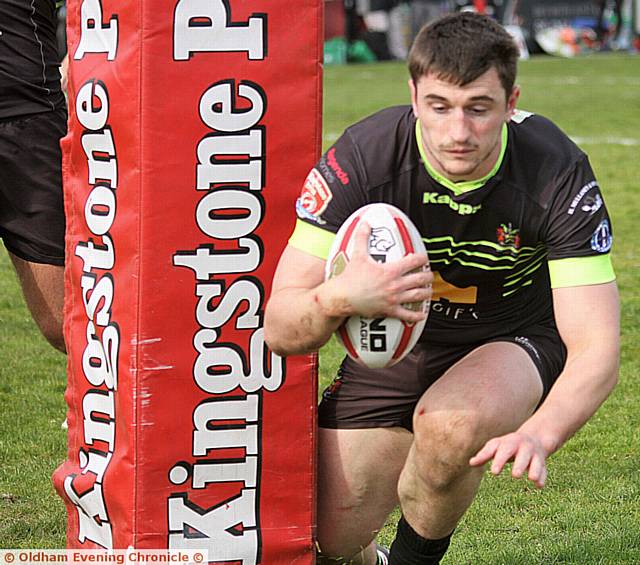 HIGH FIVES: Joe Burke dives in for Oldham's fifth try