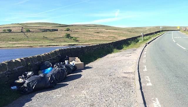 DUMPED . . . Waste bags and boxes dumped a in lay-by overlooking Dowry Reservoir on the A640 Huddersfield Road near Denshaw