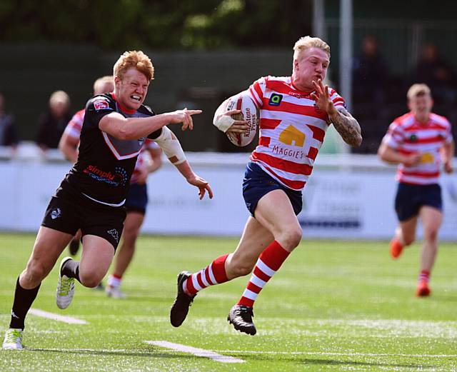 BREAK AWAY . . . Determined George Tyson bursts clear of the Broncos defence to score for Oldham. 