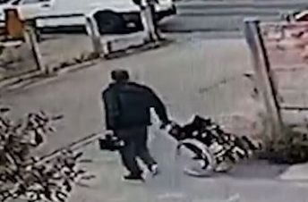 BRAZEN . . . the thief calmly strolls into the garage and takes a wheelchair BRAZEN . . . the thief calmly strolls into the garage and takes a wheelchair