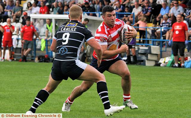 MILESTONE: Liam Thompson (right) in his 100th game for Oldham