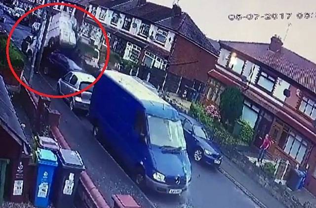 The shocking moment a stolen 18-tonne lorry crashes through Hadfield Street in Oldham, Manchester, leaving a trail of destruction in its path