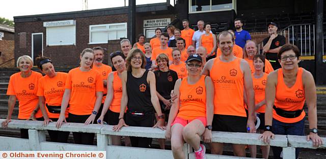 MOSSLEY Running Club member Michelle Phillips sitting on the wall with husband Chris and other members of the club
