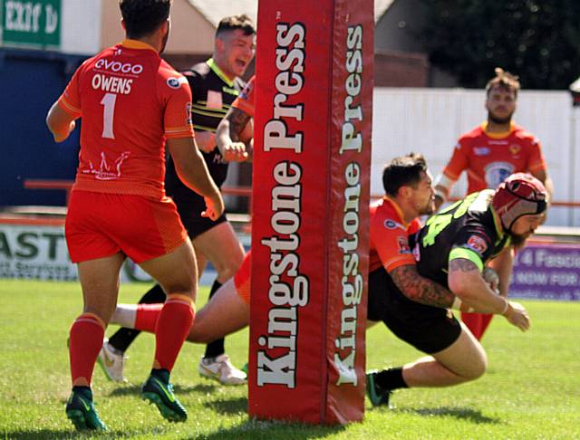 OVER THE LINE: Oldham's Michael Ward powers through to register a try