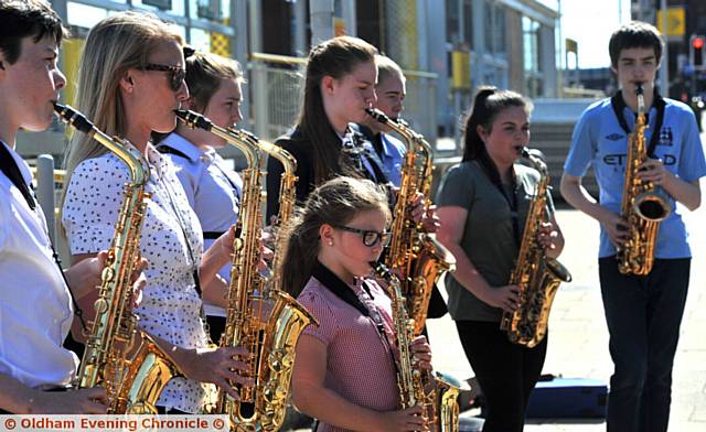 Tram Tracks pop up performance by Oldham Music Service, saxophonists at Oldham Mumps Metrolink Station.