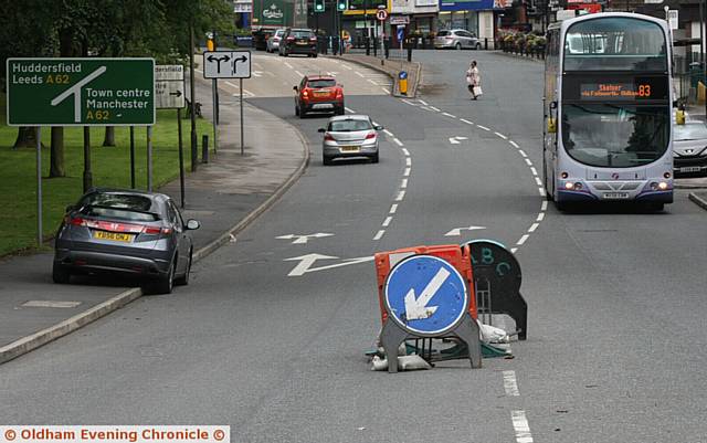 CENTRE OF ATTENTION . . . Manhole cover works on Ripponden Road, Littlemoor, Oldham
