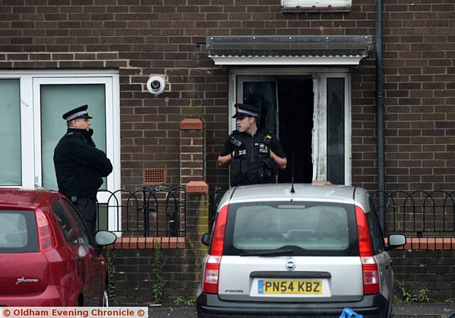 THE scene early this morning . . . the front door of the house smashed in as police ended the siege. 