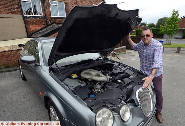 Mark Elliott, landlord at the Dog Inn, Chadderton with his crocked Jaguar