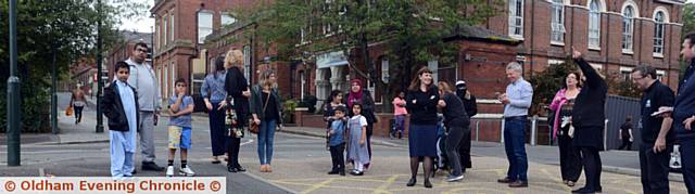 curious onlookers keep a safe distance as the swarm arrive. 