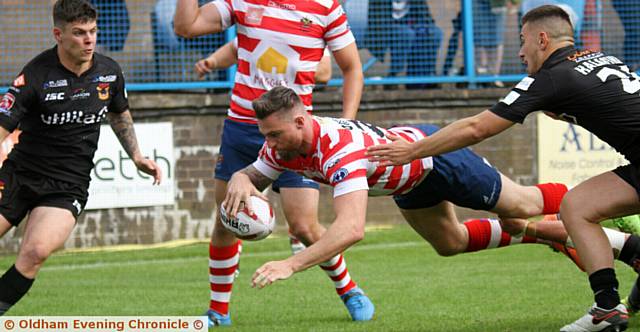 HE'S OVER . . . Danny Grimshaw scores a try as Oldham attempt to claw themselves back into the game