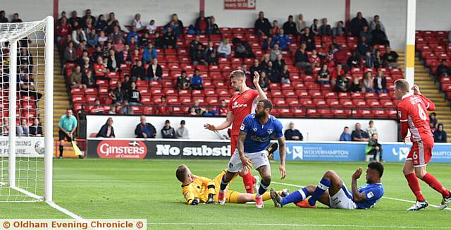 IN FRONT . . . Ryan McLaughlin's cross evades everyone and goes straight in to the net 