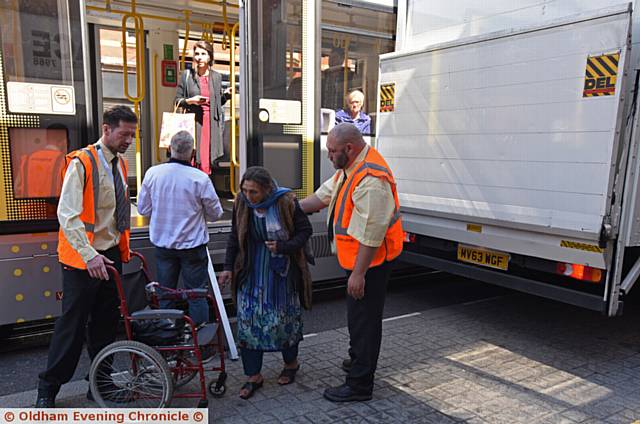 Metrolink tram and parked wagon collide on Union Street, Oldham. Passengers are helped from the tram.