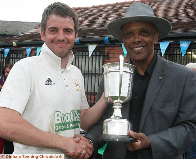 JUST THE JOB . . . Heyside captain Ryan Barnes receives the Tanner Cup from PCL president John Holder JUST THE JOB . . . Heyside captain Ryan Barnes receives the Tanner Cup from PCL president John Holder
