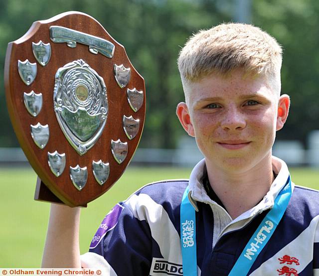SO PROUD . . . Saddleworth's Finlay Rogers with the winners' trophy