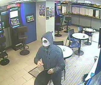 MASKED robber enters the betting shop