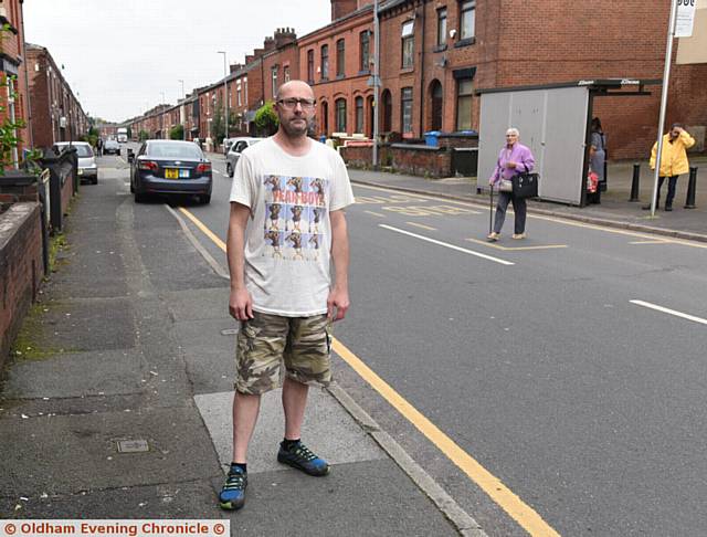 WORRIED . . . Mark Ellis on Coalshaw Green Road, Chadderton, where his  daughter Chloe was knocked down by a car
