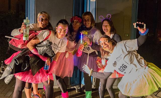 GLITTER, luminous jewellery and glow sticks at the ready . . . for these fun-loving charity walkers