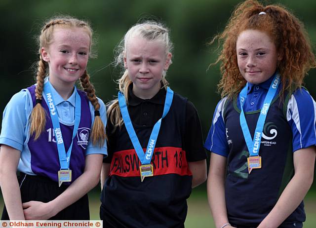 PODIUM PLACES . . . Year Sevens 1,500m champion Ella Rigby (Failsworth) is flanked by runner-up Lia Robinson (left Newman College) and Alyssa Donohue (Waterhead Academy)