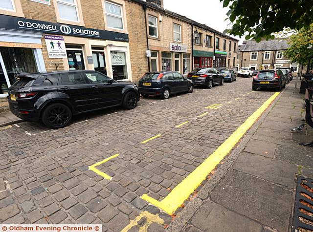 The lines, marking out a new hackney carriage rank in Uppermill's cobbled square.