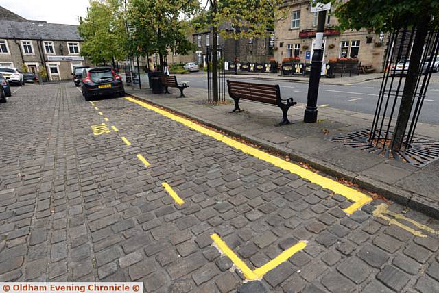 The lines, marking out a new hackney carriage rank in Uppermill's cobbled square.