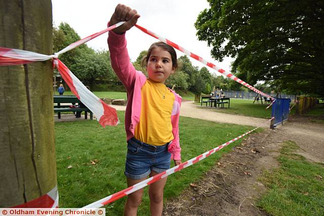 VANDALS . . . Isla Allen inspects where yobs ripped up railings at Chadderton Hall Park