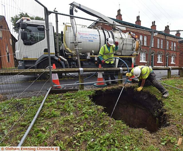 Sink hole on Acre Lane, Derker. Council workers establish it is likely to be a mains collapse and therefore United Utilities' responsibility.