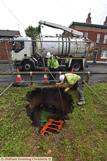 Sink hole on Acre Lane, Derker. Council workers establish it is likely to be a mains collapse and therefore United Utilities' responsibility.