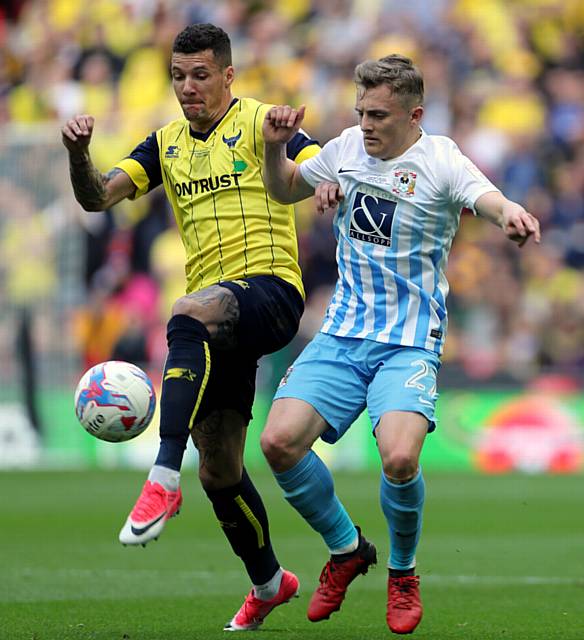 LEFT-BACK RAIDS . . . Oxford United's Marvin Johnson (left)