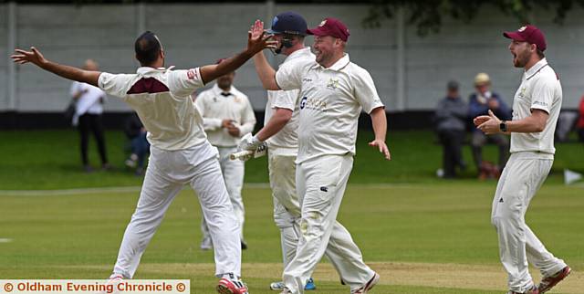 FIRST BLOOD . . Opening bowler Aqib Zulfiqar receives the acclaim of his Crompton teammates after trapping Rochdale's Ben Chapman leg before in the second over of the match.