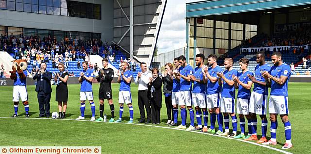 TRIBUTE . . . Athletic players and the family of Gordon Lawton pay their respects with a minute's applause