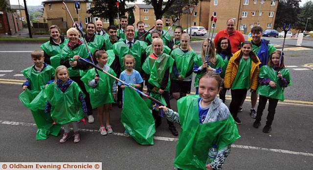 LITTER-PICKERS . . . Libby Howarth (front) with her Oldham Athletic Girls team and Darren Price, from McDonald's, and his staff at the community litter-pick on Higginshaw Road with staff and members of Oldham Athletic girls
