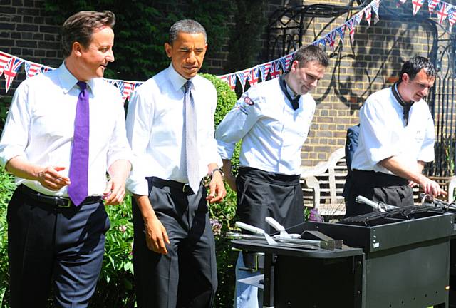 grilling . . . Graham (right), barbecues with then US President Barack Obama and Prime Minister David Cameron
