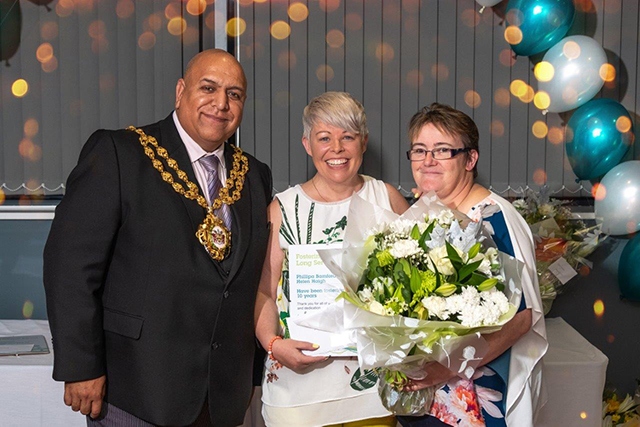 Pippa and Helen receieve their 10-year fostering award from the Mayor of Oldham, Councillor Javid Iqbal