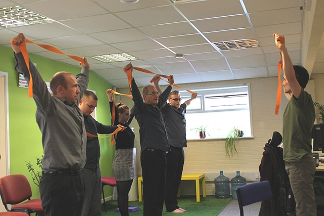 Aspect IT staff go through their yoga routine