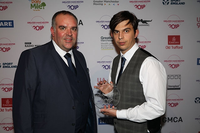 Andy Steel (right) receives his Volunteer of the Year award at Emirates Old Trafford