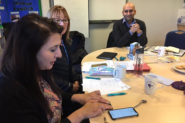 Founder of the Women’s CHAI Project, Najma Khalid, is shown how to use the AF detection devices with Health Innovation Manchester