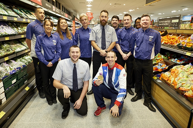 Etienne Stott MBE with the staff at the refurbished Aldi store Etienne Stott MBE with the staff at the refurbished Aldi store