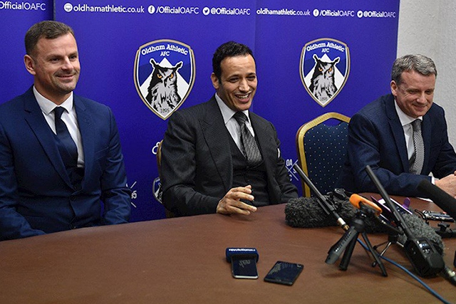 Low profile: Athletic's Moroccan owner Abdallah Lemsagam pictured (centre) at his unveiling in January. Then manager Richie Wellens (left) and then chief executive Mark Moisley were soon shown the door.