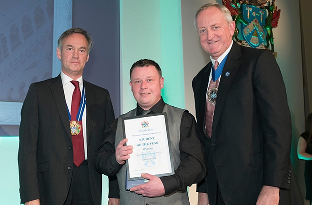 Stuart Smith (centre) receives his plastering award