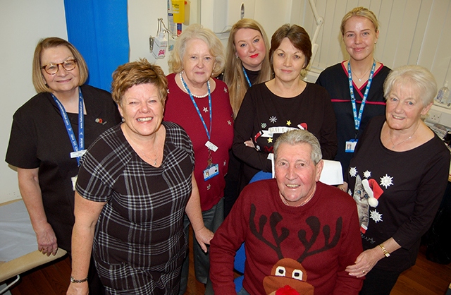 Pictured is Tommy Flannagan (bottom of picture) with his wife Mavis (to the immediate right of him) plus the team at the Medlock Medical Practice 