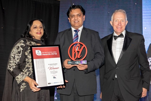 Oldham's Dr Zahid Chauhan (centre) receives his Homeless Friendly award