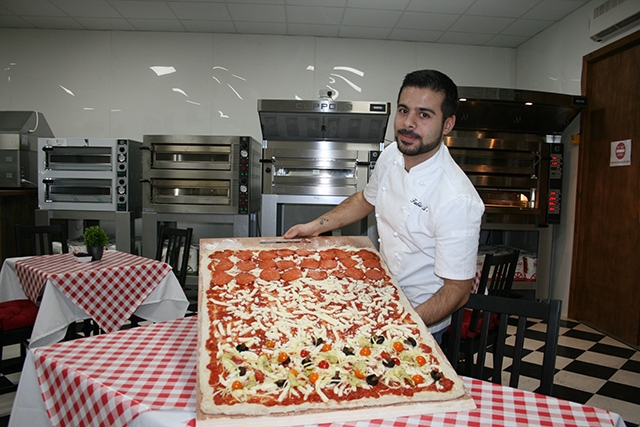 Have a go at the charity Pizza Challenge at Linda Lewis Kitchens' Oldham base. Pictured is chef Fabio Aurelio.