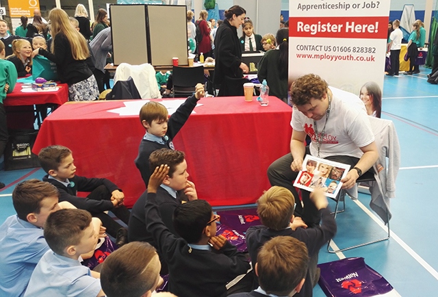 Year 5 children listen at the MPLOY Youth stall