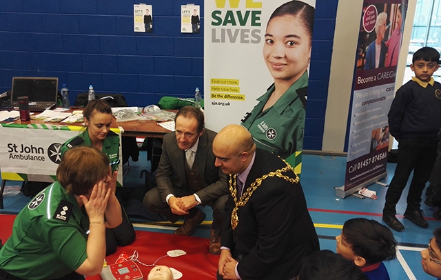 The Mayor of Oldham, Cllr Shadab Qumer, and OMBC Director of Education Andrew Sutherland (centre) at the St John Ambulance stall