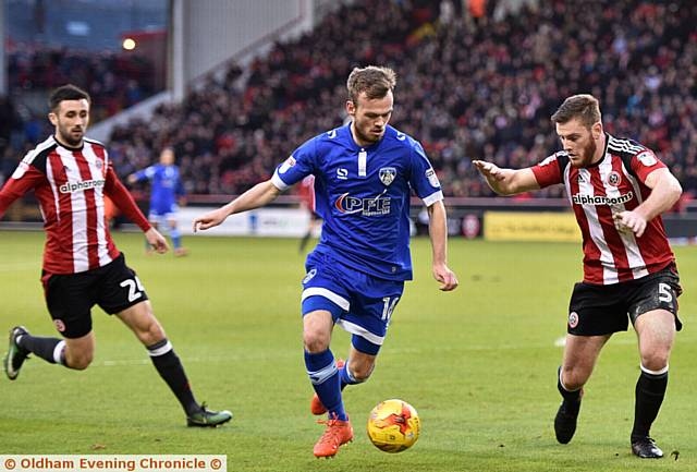 Athletic defender Cameron Dummigan (centre)