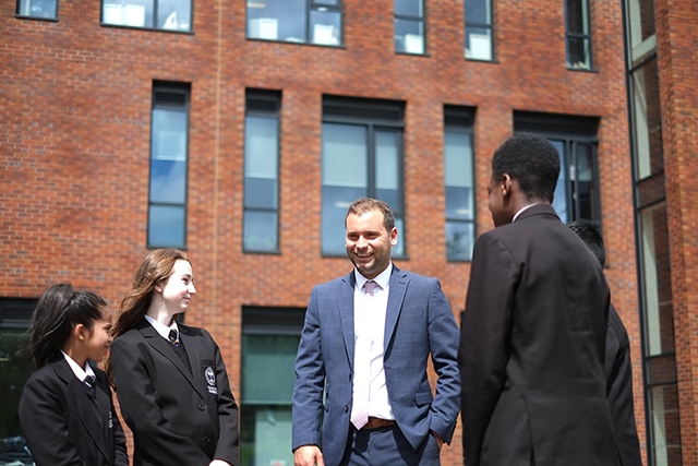Oldham Academy North headteacher Chris Davis with some students. Oldham Academy North headteacher Chris Davis with some students.